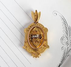 "A beautifully detailed antique Victorian locket circa 1875; crafted in 14k yellow gold featuring a romantic double heart design on the front cover, accented by delicate Etruscan-style filigree work and creamy white seed pearls. The back is plain and could be engraved with your choice of monogram initials, or perhaps a special date; with its deep inner chamber it's perfect for a photo or small keepsake such as a lock of hair. Please convo me before purchase if you are interested in the details o Pearl Locket, Engravable Jewelry, Victorian Locket, Heart Motif, Custom Gift Boxes, Double Heart, Seed Pearl, Engraved Jewelry, Locket Necklace