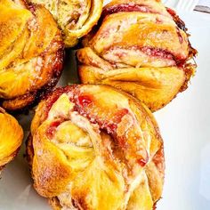 several pastries sitting on top of a white plate