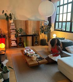 a woman sitting on top of a couch in a living room