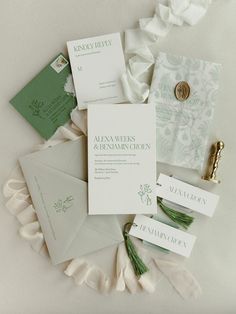 the wedding stationery was laid out on top of each other, including cards and envelopes