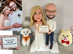 a wedding cake topper with a bride and groom holding a sign