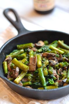 a skillet filled with stir fry vegetables on top of a table