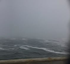 the ocean is covered in fog and water