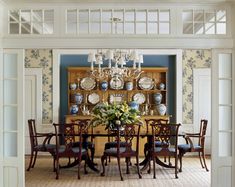 a formal dining room with blue walls and white trim