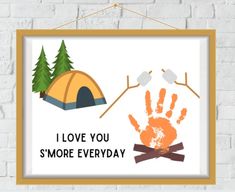 a frame hanging on a brick wall with an orange handprint that says i love you smore everyday