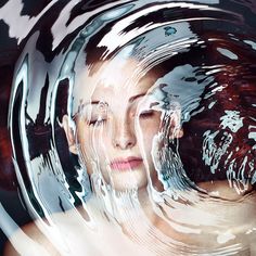 a woman's face is reflected in the water