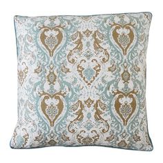 a blue and brown pillow with an ornate design on the front, sitting on a white background