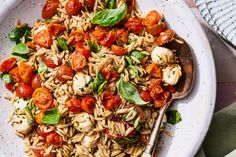 a white bowl filled with pasta and tomatoes