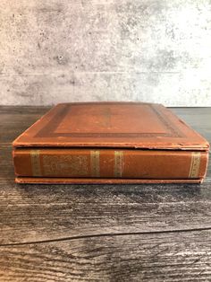 an old book sitting on top of a wooden table