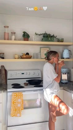 a woman standing on her legs in the kitchen