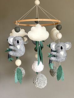 a mobile with two koalas hanging from it's sides