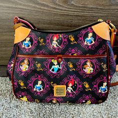 Disney 2017 Princess Half Marathon Dooney And Bourke Disney Resort Dooney & Bourke 2017 Princess Half Marathon Crossbody Stitched Leather Trim Zip Top Closure With Leather Zipper Pull Exterior Pocket Interior Zippered Pocket Two Interior Open Pockets Adjustable Shoulder Strap With Buckle Interior Key Hook With Canvas Strap Golden Hardware Fully Lined Dooney & Bourke Embossed Metal Label On Front Dooney & Bourke Embossed Leather Label Inside Approx10" H X 11" W X 4" D Disney Dooney Bourke Handbags, Dooney And Bourke Shoulder Bag, Disney Dooney And Bourke, Dooney And Bourke Disney, Hobo Purses Dooney & Bourke, Princess Half Marathon, Disney Board, Embossed Metal, Key Hook