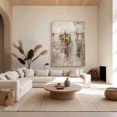 a living room filled with furniture and a painting on the wall