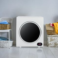 a white microwave oven sitting on top of a hard wood floor next to a wicker basket