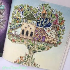 an open book with a drawing of a tree house on the front and back cover