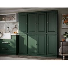 an image of a kitchen setting with green cupboards and white counter tops on the wall