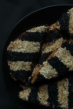 black and white striped cookies on a plate with sprinkles in the middle