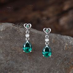 Product Detail Material: 925 Sterling Silver, 10k/14k/18k Solid Rose/White/Yellow Gold, Platinum Quantity: 2pcs (a pair) earrings Center Stone: 6x8mm Pear Cut Lab Emerald Side Stones: Round Cut Lab Emerald and Moissanites Custom Service 1, Gemstones can be replaced with others. 2, All metal can be customized. 3, The earrings can be customized according to the design you want. Please contact us if you need any personalized custom earrings. We will try our best to meet your needs. Only you can't think of it, we can't do it without us. Shipping It's made-to-order jewelry, it will take 2-4 weeks to make it. Once the pendant/necklace is finished, it will be sent by USPS, FedEx or DHL. Return & Refund There is a 30-day return guarantee. But as it's handmade pendant/necklace, handcrafted fee and Elegant Green Heart Cut Earrings, Formal Green Heart-shaped Earrings, Formal Dangle Heart Earrings In Sterling Silver, Emerald Pear-shaped Fine Jewelry Earrings, Elegant Formal Heart Gemstone Earrings, Elegant Gemstone Heart Earrings For Formal Occasions, Fine Jewelry Emerald Teardrop Earrings, Emerald Teardrop Earrings Fine Jewelry, Sterling Silver Pear-shaped Fine Earrings