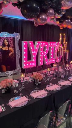 a party with balloons, tables and chairs in front of a large sign that says lyrton