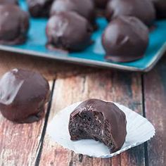 chocolate covered cookies sitting on top of a wooden table