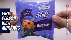 someone holding up a blueberry muffin bag