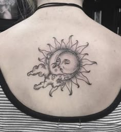 a woman with a sun and moon tattoo on her back