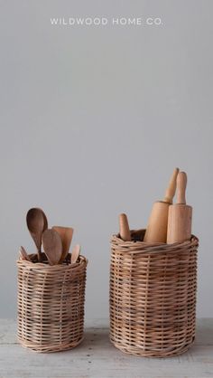 two baskets with wooden spoons and utensils in them