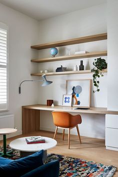 a living room filled with furniture next to a wall mounted book shelf on top of a hard wood floor