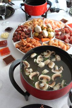 a table topped with lots of different types of food on top of plates and bowls