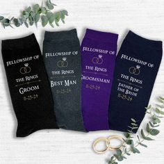 three pairs of wedding socks with rings and the words, fellowship of the rings, best man