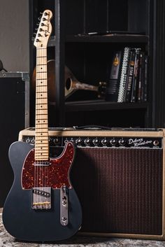 an electric guitar and amp sitting next to each other