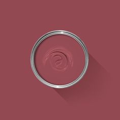 a red paint can with a long shadow