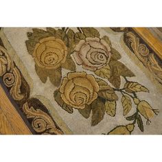 an area rug with flowers and leaves on it