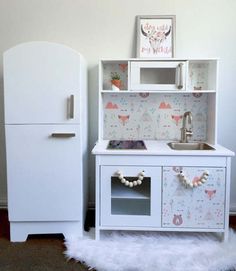 a toy kitchen with a refrigerator and sink