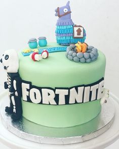 a birthday cake decorated with fondant and decorations