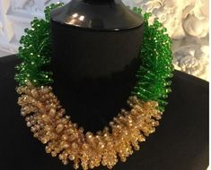 Dramatic 21" lucite beaded necklace. This vintage unsigned beaded masterpiece is exceptionally well made with 100's of tiny faceted lucite beads in shimmering gold and vivid emerald green. The style and quality remind us of the Italian designing duo Coppola e Toppo. This is a true runway piece. Offers welcome.●Materials: lucite beads ●Length: 21" ●Shipping: Free Domestic Shipping - limited time!●Linda's Designers Group features a collection of luxury estate sale handbags, vintage statement jewel Celebration Green Beaded Necklace With Colorful Beads, Green Large Beads Party Necklace, Green Large Beads Necklace For Party, Green Handmade Beaded Necklaces For Celebrations, Green Large Beads For Party, Green Beaded Necklaces With Round Beads For Party, Green Beaded Necklaces For Celebration, Green Beaded Jewelry For Mardi Gras, Green Polished Beads Necklace For Party