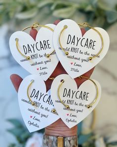 three heart shaped key chains with words on them in the shape of hearts that say, day care and not be the same