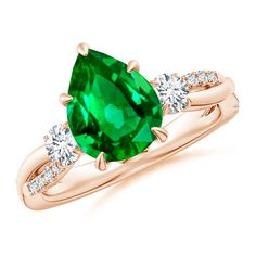 a green ring with two diamonds on top and the center stone is surrounded by an oval cut