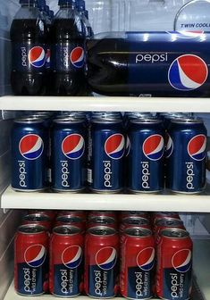 a refrigerator filled with soda and pepsi cans