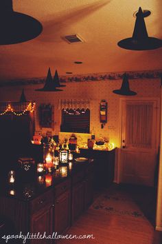 a kitchen filled with lots of candles and lights on the counter top next to a doorway