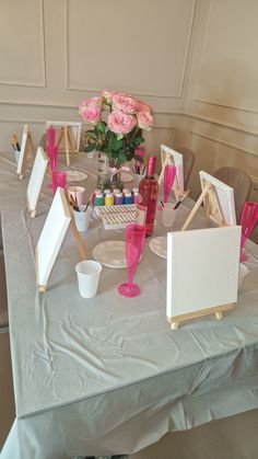 a table topped with pictures and pink flowers