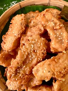 some fried food in a bamboo basket on a table