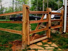 a wooden fence with cars parked behind it