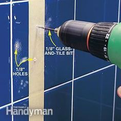 a person using a drill to fix a tile wall