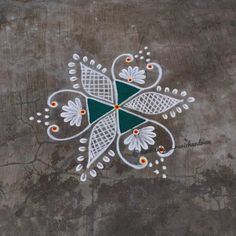 an artistic design painted on the ground in white and green colors with dots around it