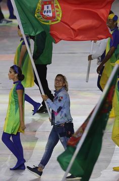 a group of people holding flags walking down a street