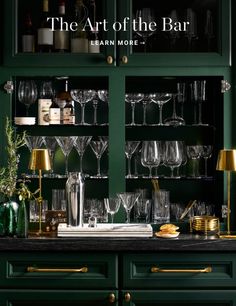 the art of the bar by jean more is on display in this green cabinet with gold trim