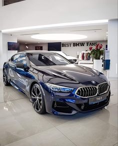 a blue bmw car parked in a showroom