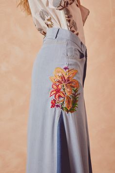 Blue denim skirt with two-tone design, belt loops, button and zip closure at the front. Featuring three front pockets, high-waist fit and long length. It has two embroidered flower motifs: one at the top right and a larger one at the bottom left. Flower Motifs, Blue Denim Skirt, Skirt Denim, Aruba, Embroidered Flowers, Long Length, Denim Skirt, Two Tone, Blue Denim