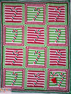 a green and red quilt with candy canes on it